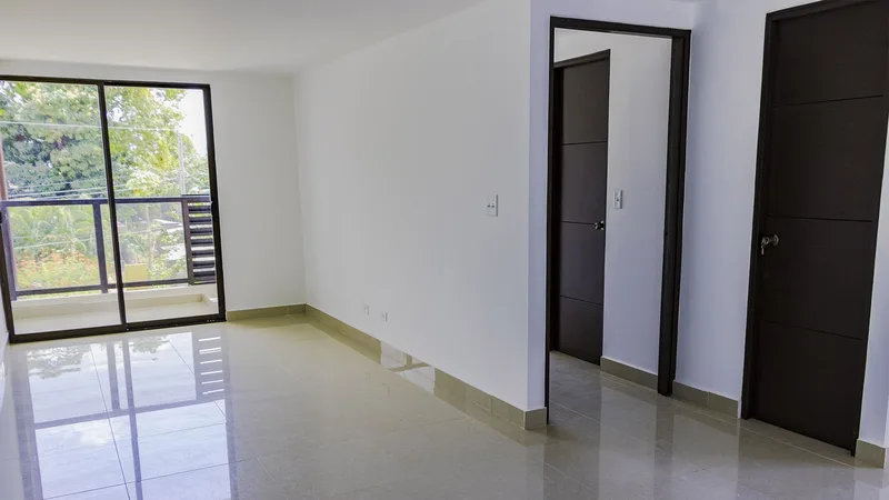 Sala-comedor entregada de un apartamento en Acacias Juan Díaz, con piso de porcelanato y salida al balcón