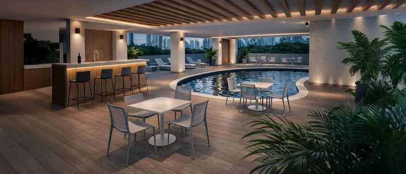 Piscina y terraza social iluminadas de noche en PH Omar Park View