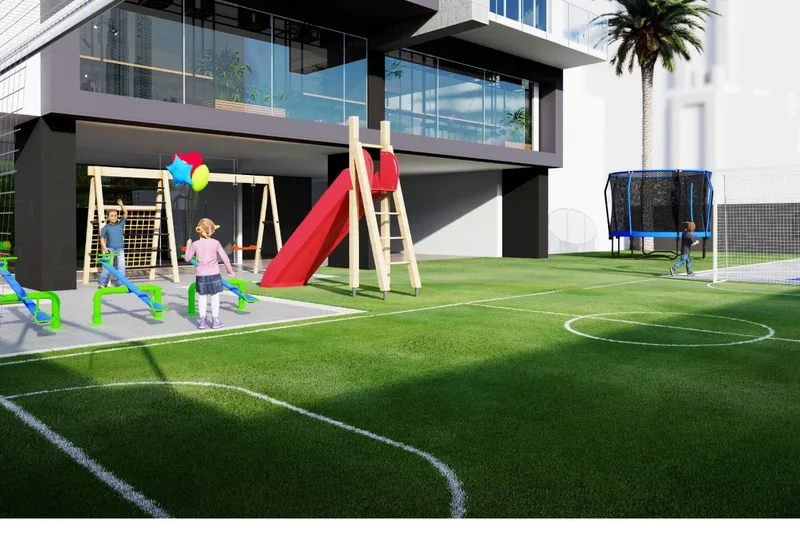 Área de juegos infantiles y cancha deportiva al pie de la torre Sky Parc
